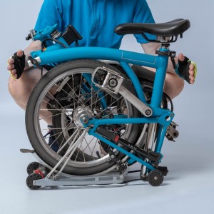 Packshot vélo pliable avec une femme en tenue de cycliste